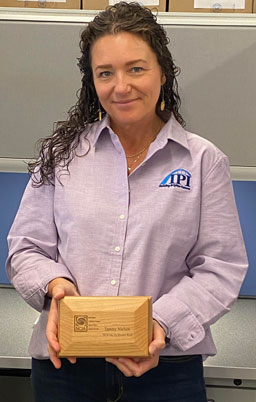 Tammy Nielsen holding engraved NCIA award box